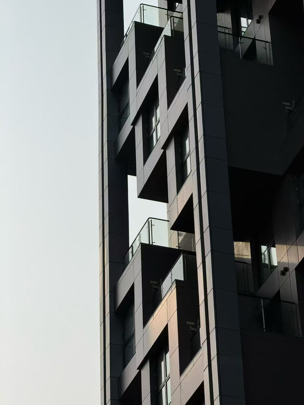 Stepped modular facade with dark geometric panels